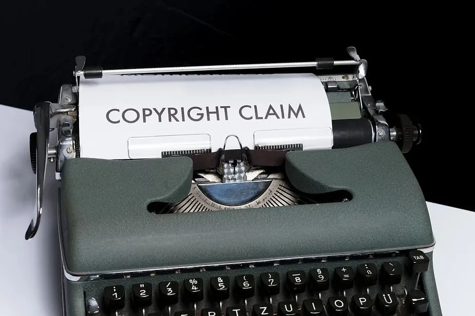 Typewriter with a sheet of paper reading COPYRIGHT CLAIM