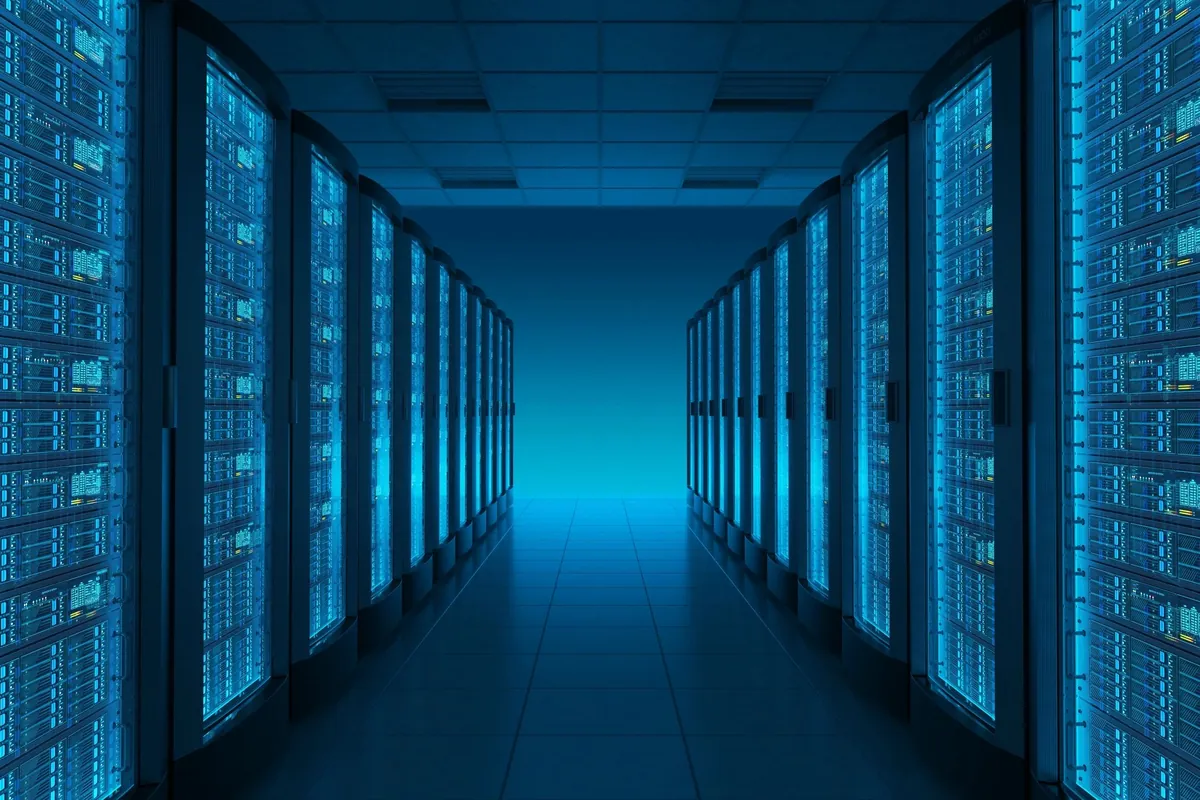 Long corridor of server racks lit in blue